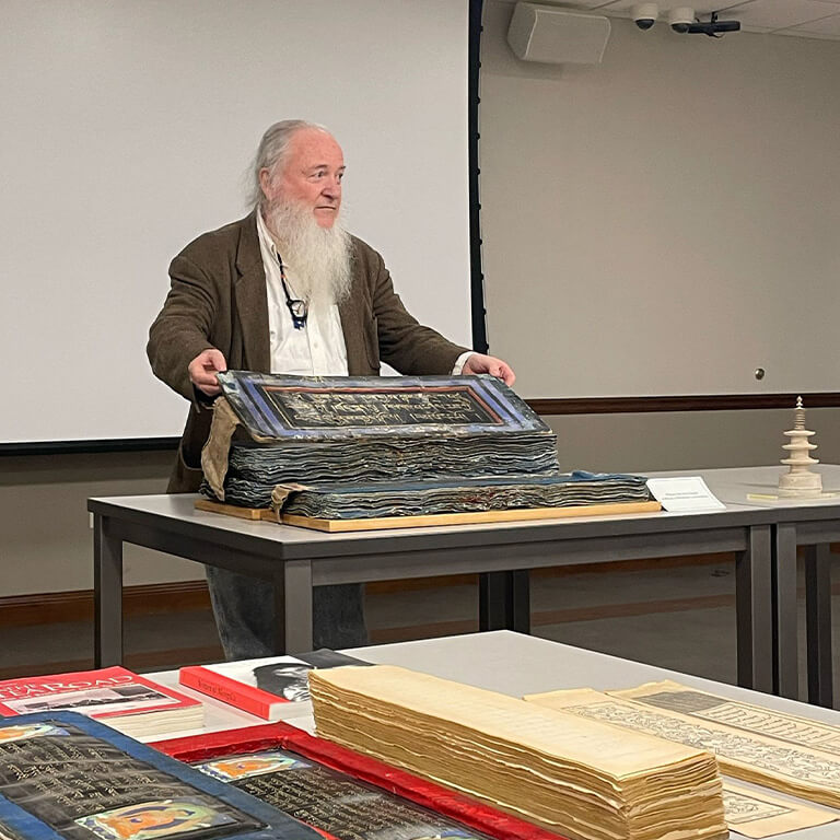 Jim Canary is holding an object.