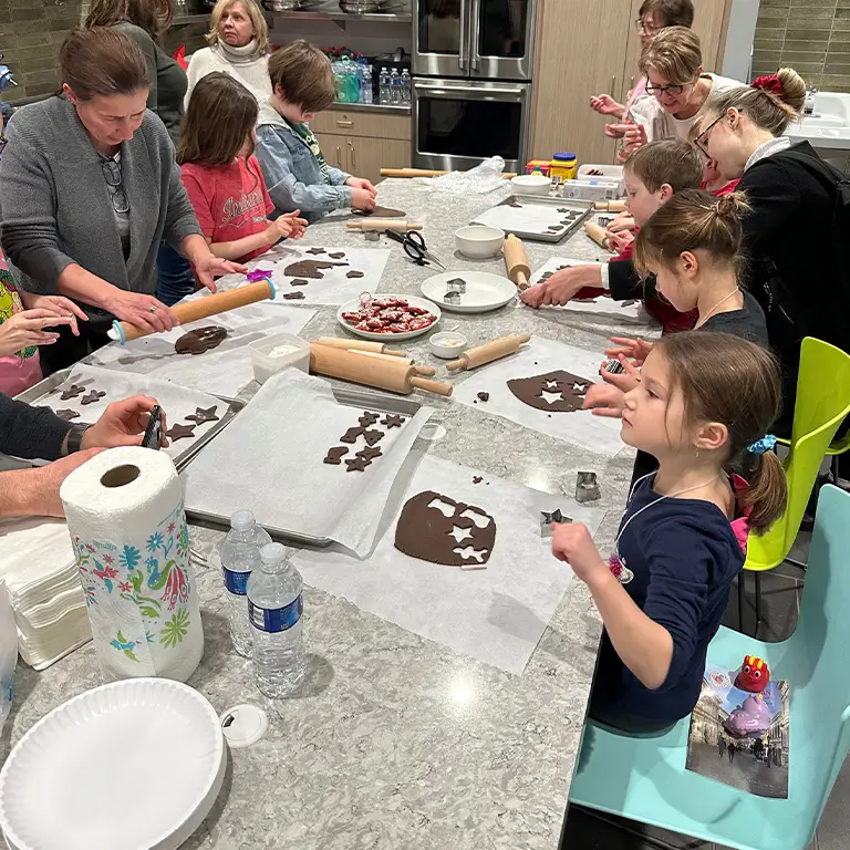 Faculty, Staff, Students and community members making treats for the Mikulás Nap celebration.