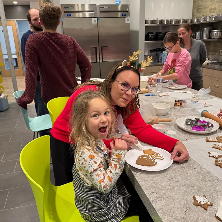 Faculty, Staff, Students and community members making treats for the Mikulás Nap celebration.